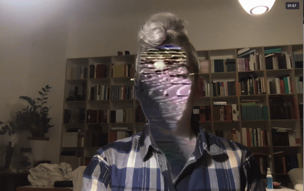 A photograph of Room & Board's director, Julia Pelta Feldman, with their face replaced by colorful video scanlines.